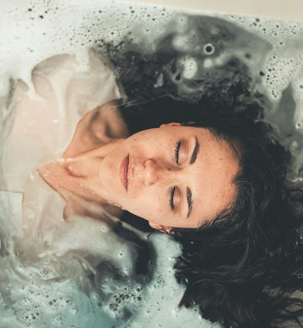 Woman meditating peacefully with a calm expression on her face.
